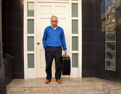 Senior evicted from his house with suitcase