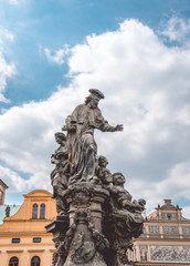 Ancient statue on the Charles Bridge. Architecture of the daynings of Prague