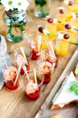 Zelfklevend Fotobehang Beautiful row line of different alcohol and non-alcohol cocktails. Snack cocktails with tomato juice and shrimps. Vertical photo. Catering table for party. © linortis