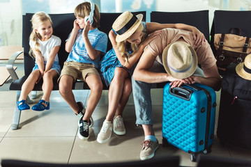 family waiting for boarding at airport