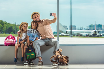family taking selfie in airport