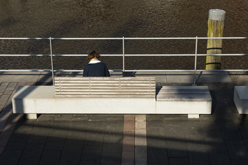 Woman is sitting on the bench