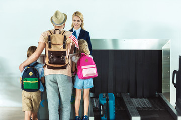 family at check in desk at airport