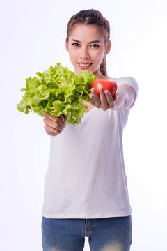 young woman in white t-shirt showing green vegetable and tomato isolated on white background. with clipping path