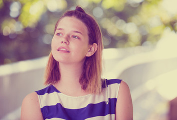 Portrait of girl on summer green landscape