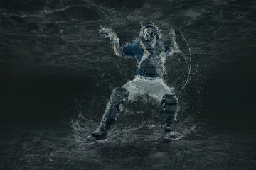 Baseball players in action under water