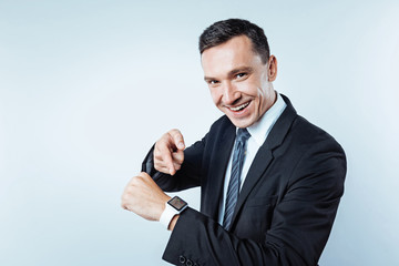 Confident man pointing toward electronic wrist watch