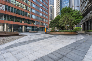 empty pavement and modern buildings in city.