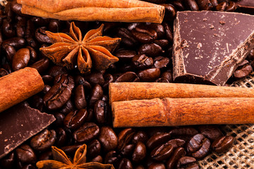 Cinnamon and other species lie on coffee beans