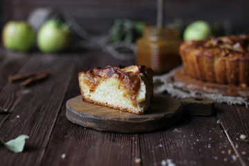 Apple pie with salted caramel on a wooden background