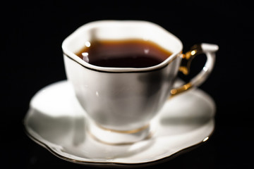 Porcelain cup with black tea