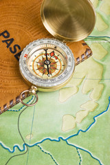 Fototapeta na wymiar compass and passport on the map