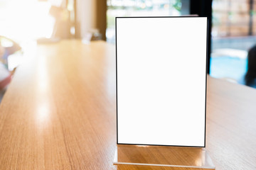 Mock up Menu frame in Bar restaurant ,Stand for booklets with white sheets of paper acrylic tent card on wooden table on.