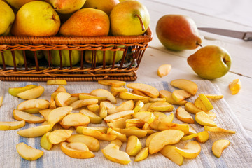 group of pears and sliced pears on white wooden boards with a textile napkin. Homework