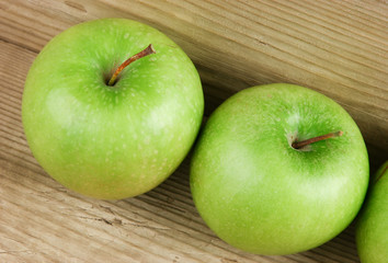 green apples on a wooden background