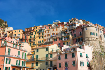 Fototapeta na wymiar Magnificent daily view of the Manarola village in a sunny summer day. Manarola is one of the five famous villages in Cinque Terre (Five lands) National Park. Liguria, Italy, Europe
