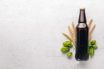 A bottle of beer, hops and grain. Top view. Free space for text.