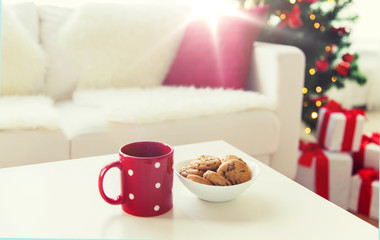 close up of christmas cookies and red cup on table