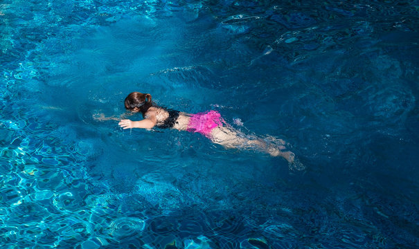 woman swimming in a pool .
