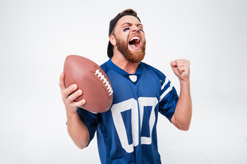 Excited screaming man fan holding rugby ball.