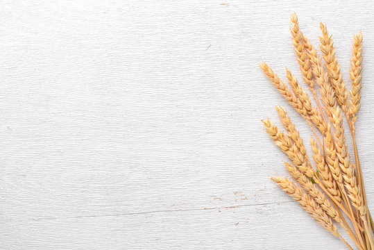 Wheat on a wooden background. Top view. Free space for text.