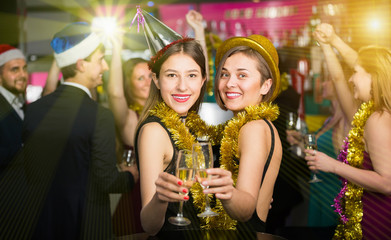 Portrait of smiling females and males in caps and garlands