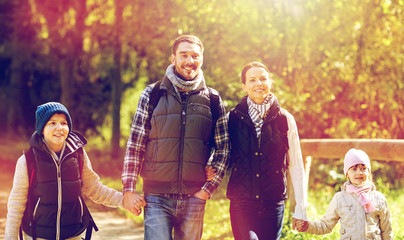 happy family with backpacks hiking