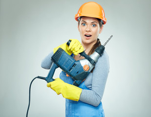 Woman builder portrait with drill tool.