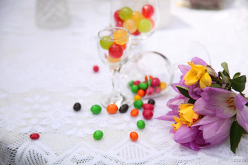 A festive table decorated with birthday cake with flowers and sweets. A table with a cake for the birthday of the child. Birthday party for children.