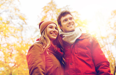 happy young couple walking in autumn park