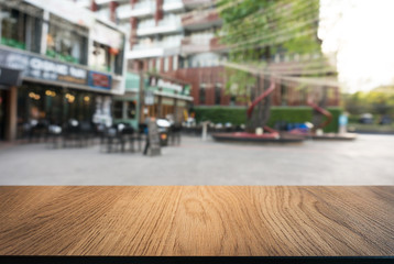 Empty wooden table in front of abstract blurred background of coffee shop . can be used for display Mock up  of product