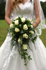 Bride holding cascading bridal bouquet - 171561569