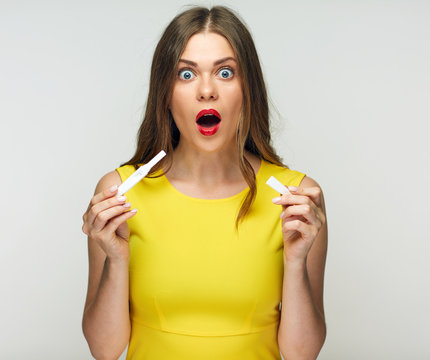 Frustrated emotional woman holding pregnant test pack.