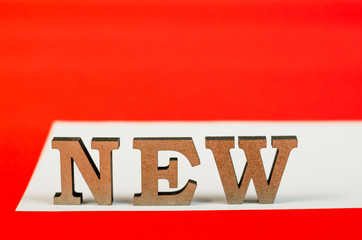 sign from wooden letters new year on white and red background. Words new year 2018.