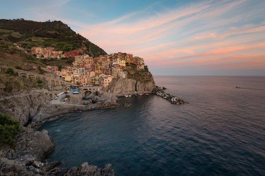 Magnificent sunset view of the Manarola village. Manarola is one of the five famous villages in Cinque Terre (Five lands) National Park. Liguria, Italy, Europe