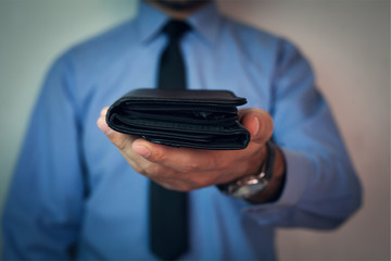 Businessman holding wallet.