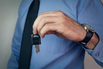 Businessman holding keys.