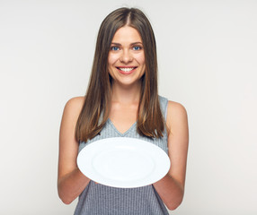 Woman holding white plate. Smiling girl waitress