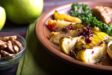 Slices of baked apple  with walnut and cranberry