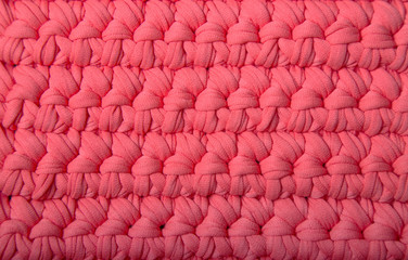 Obraz premium Texture. Pink crochet of knitted yarn fabric