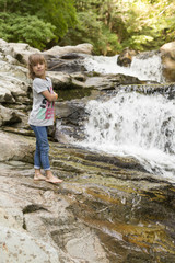 Girl next to the Waterfall of the bucket in the Selva de Irati in Navarra, Spain.