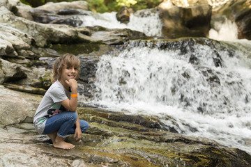 Girl next to the Waterfall of the bucket in the Selva de Irati in Navarra, Spain.