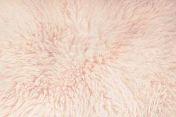 Pastel and beige fur close up background. Texture, abstract pattern.