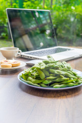 Top view home office table with laptop, coffee and cookie on wooden table. Modern office top view at home. New life style. Concept : business and office.