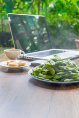 Top view home office table with laptop, coffee and cookie on wooden table. Modern office top view at home. New life style. Concept : business and office.