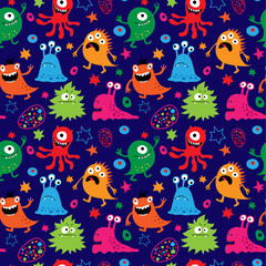Seamless pattern with cute aliens on a blue background