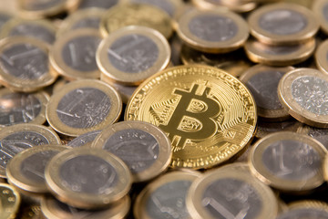 bitcoin on the background of coins of one euro