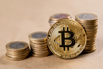 bitcoin on the background of coins of one euro