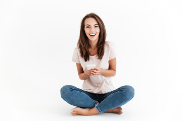 Happy brunette woman holding smartphone in hands
