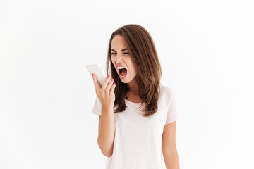 Fototapeta premium Brunette woman screaming on her smartphone